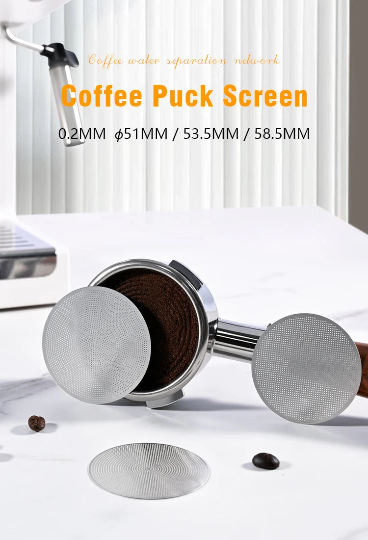 Stainless steel espresso coffee puck screens with portafilter and coffee beans on a countertop.