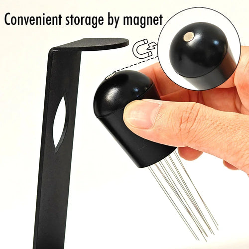 Magnetic espresso distributor tool for easy storage, held by hand above metal stand
