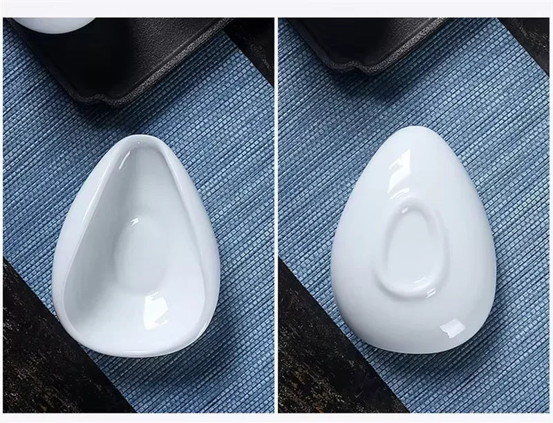 White ceramic espresso dosing bowl with oval shape on blue textured mat