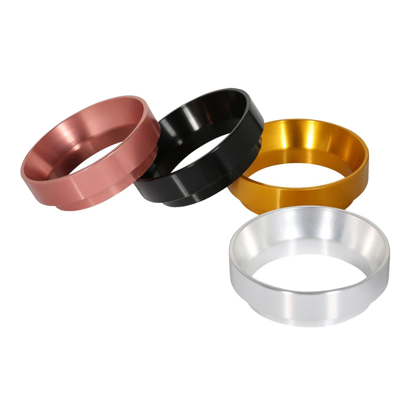 Four espresso dosing rings in rose gold, black, gold, and silver on white background