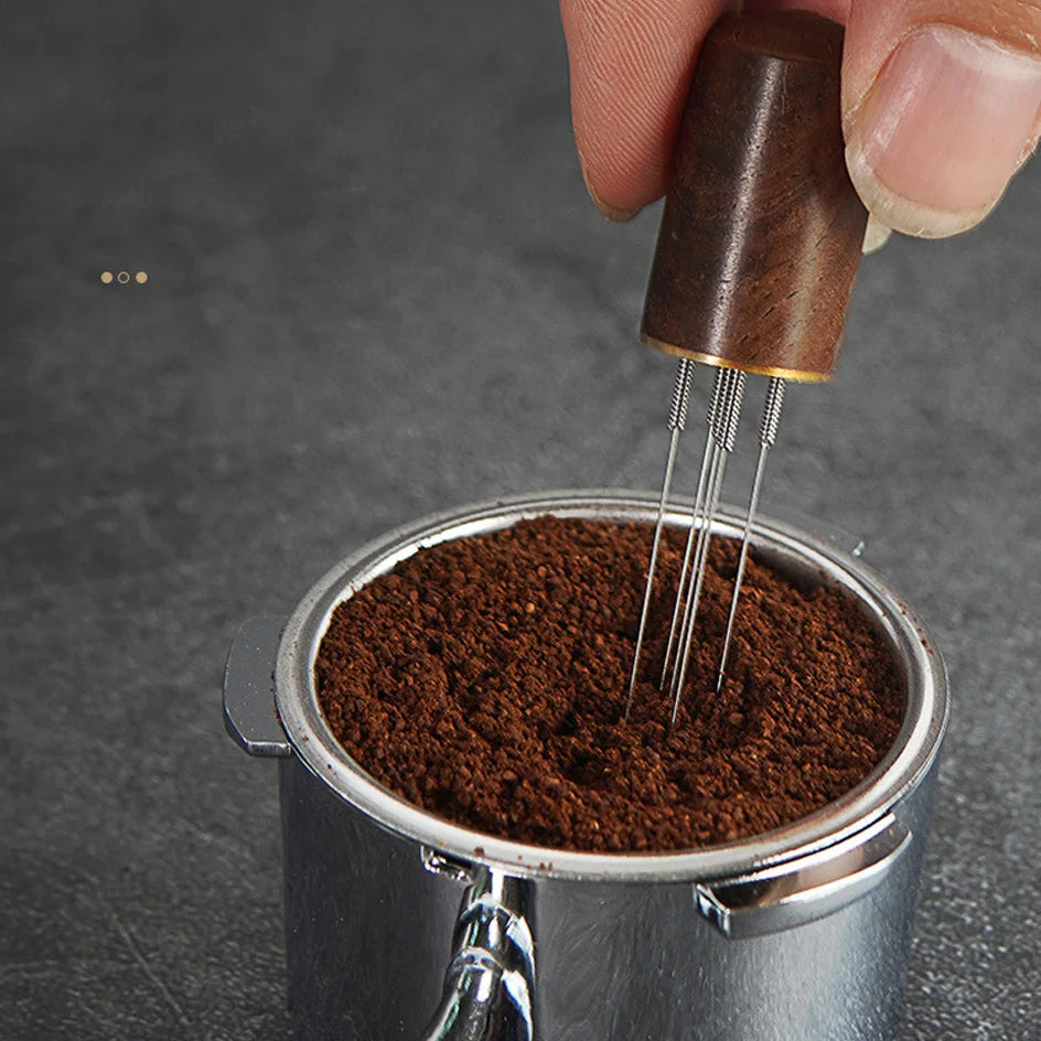 Espresso WDT tool stirring ground coffee in a portafilter on a gray countertop