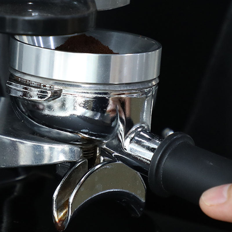 Espresso portafilter with dosing ring under grinder dispensing fresh coffee grounds