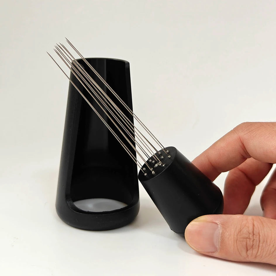 Espresso distribution tool with fine needles and black holder for home barista coffee setup