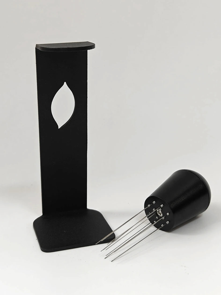 Espresso distribution tool with metal stand and multiple needle prongs for coffee preparation